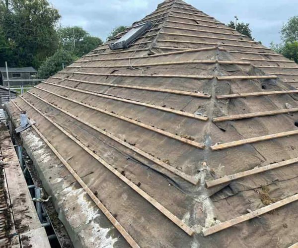 This is a photo of a hip roof that has been stripped back to the battens, and is awaiting a new roof covering to be installed. Works carried out by KJI Roofing Rothwell